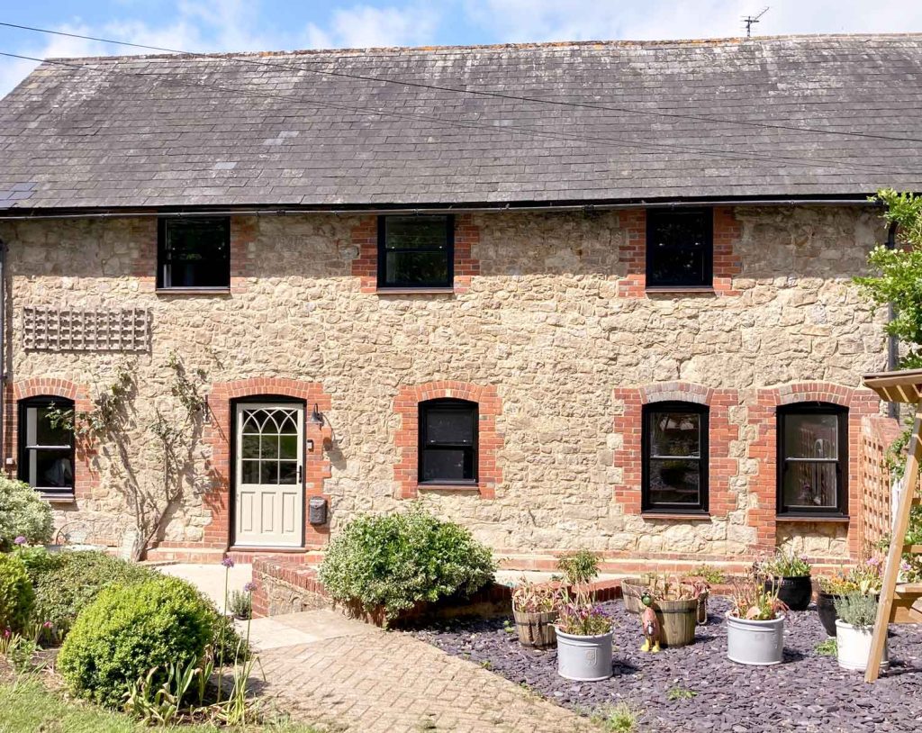 Black sliding sash windows and cream entrance door