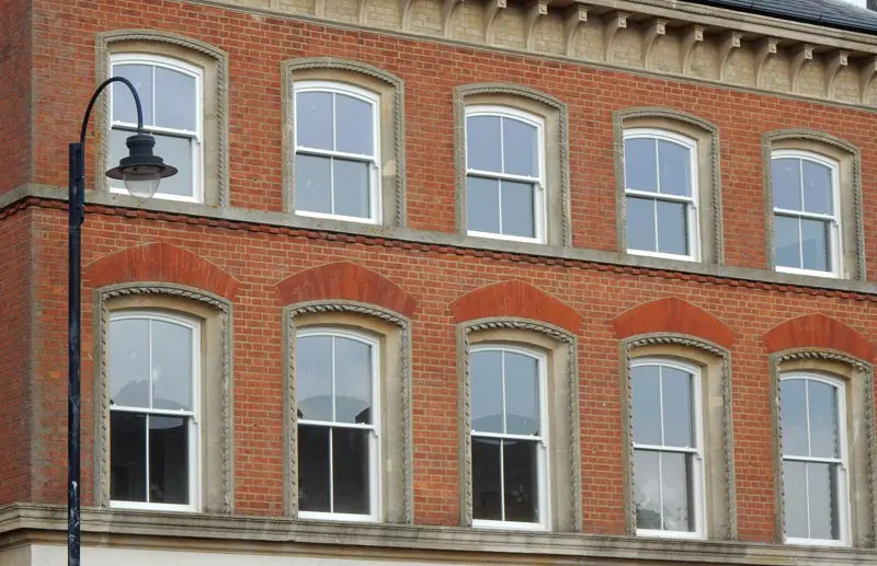Old town building with white sliding sash windows