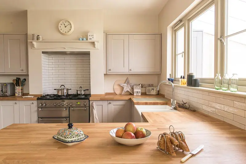 Green timber flush casement windows above kitchen sink