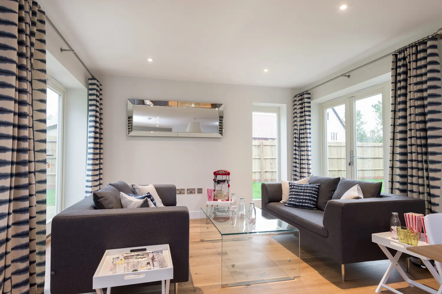 Living area with white French doors and lipped casement windows