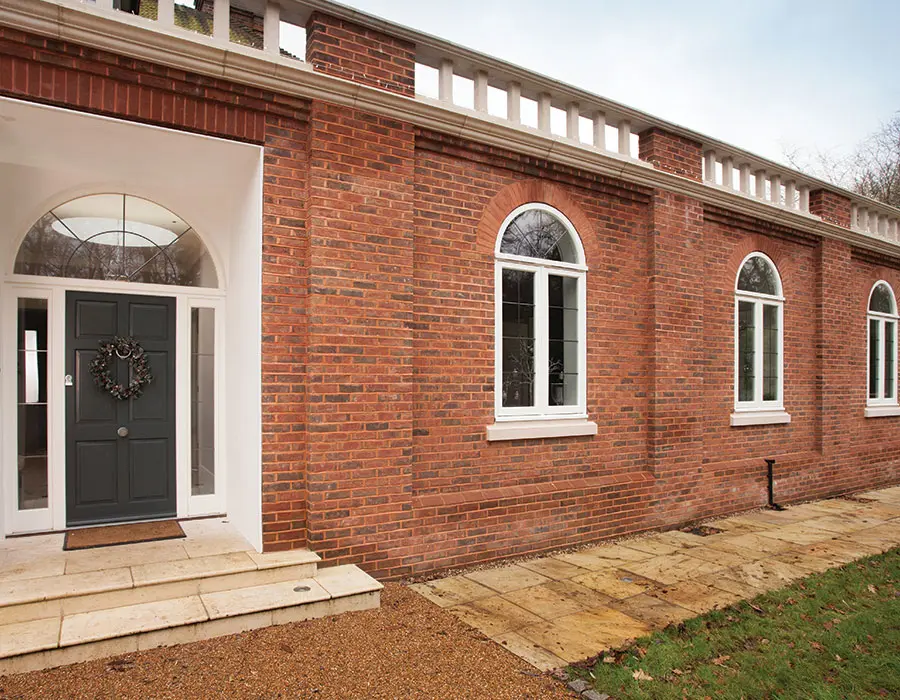 Black entrance door with white casement windows