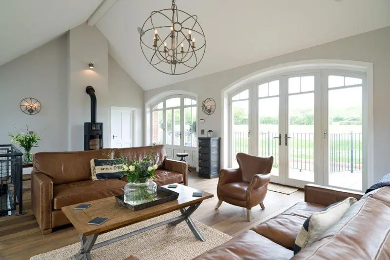 Smart living area with white French doors and leather sofas