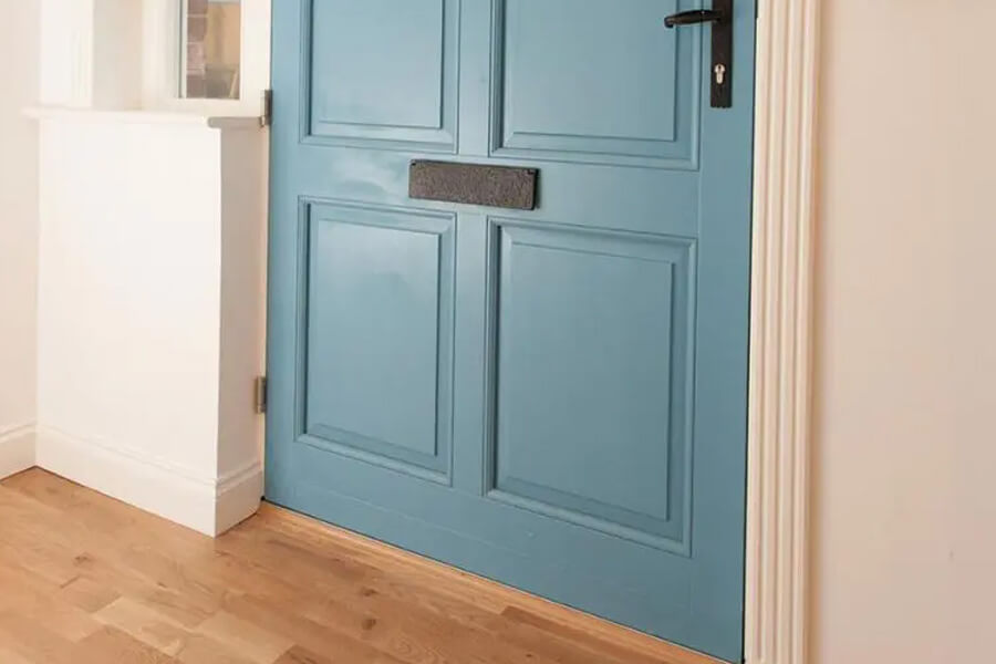 Close up of bottom half of a blue entrance door