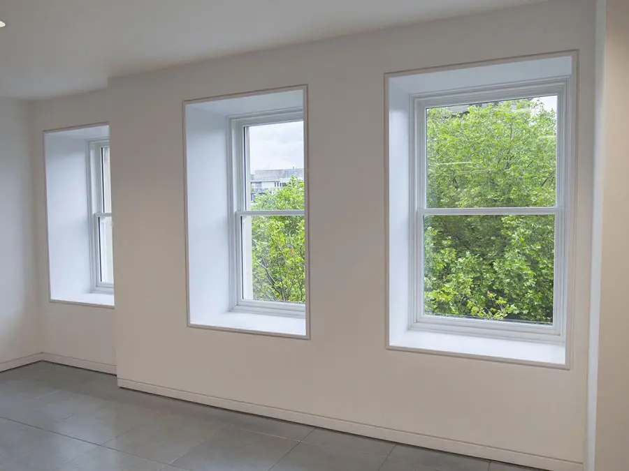 Inside view of a city building with white sliding sash windows