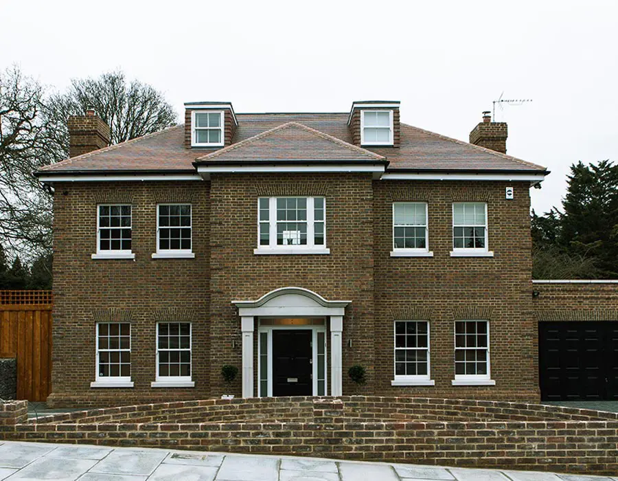 Brick house with bespoke sash windows and black front door