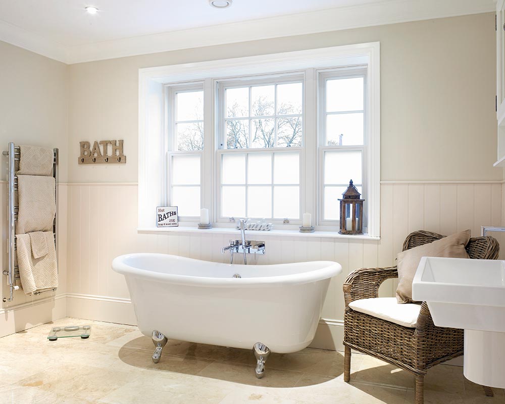 A modern bathroom featuring white timber sliding sash windows