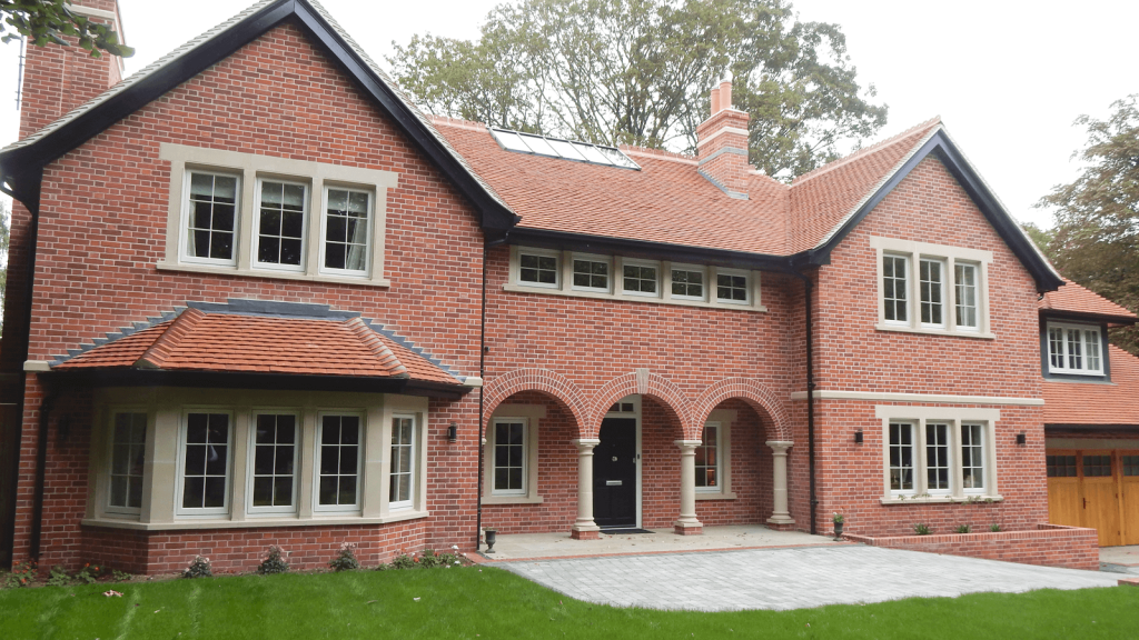 A large red brick house featuring flush casement windows