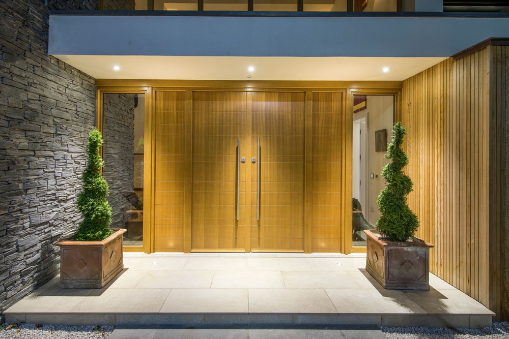 Exterior shot of a front of a house with twin timber entrance doors