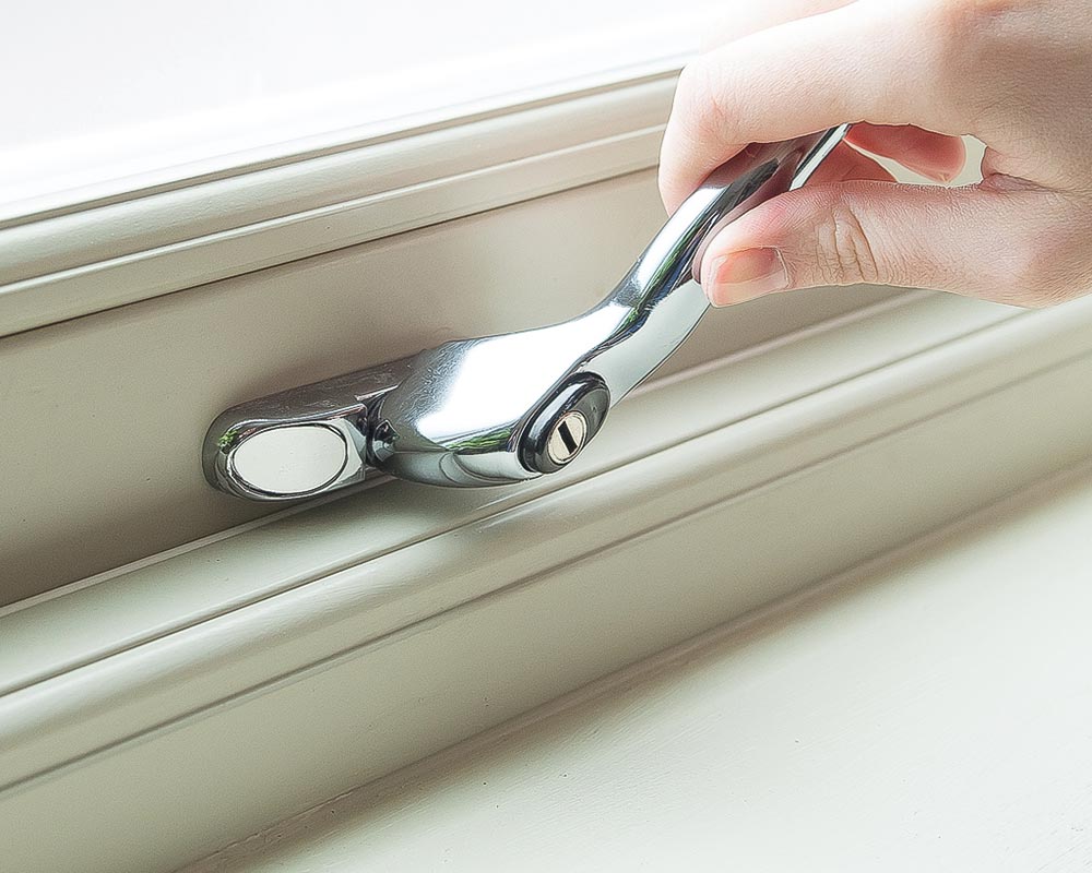 Close up of a hand opening a window